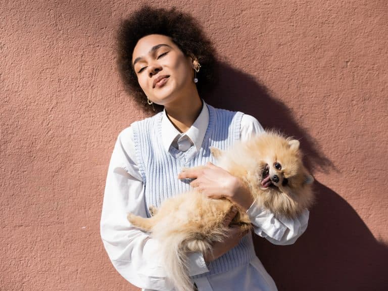 Woman holding teddy bear dog