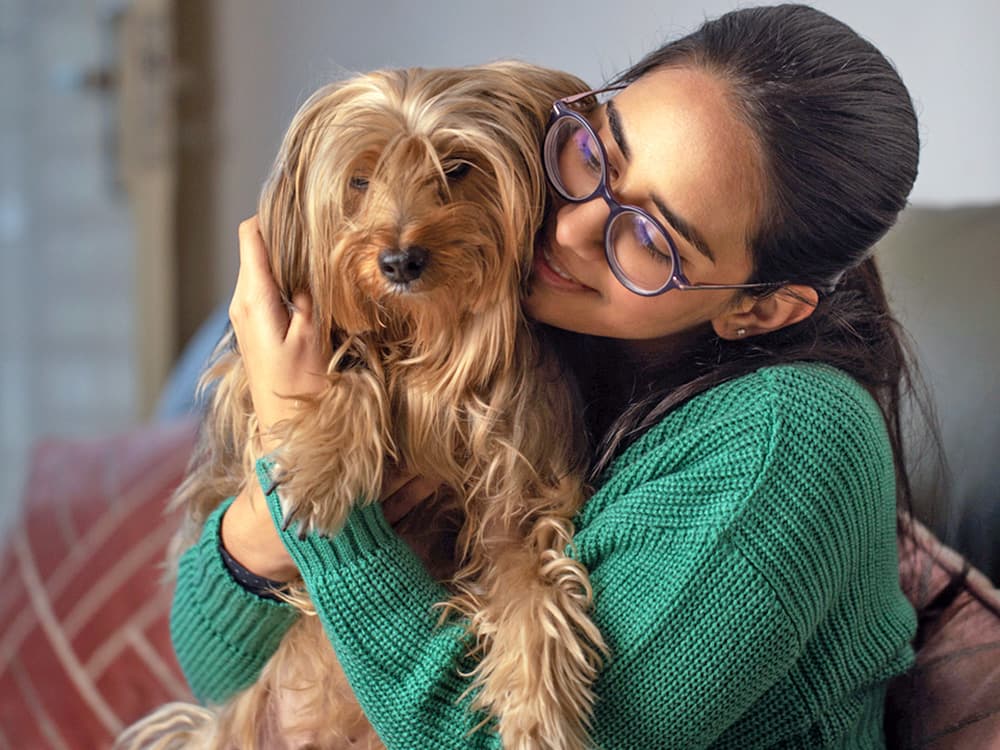 woman hugging yorkshire terrier