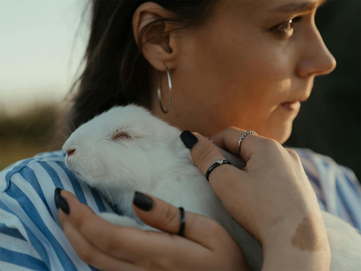 Woman cuddling with rabbit