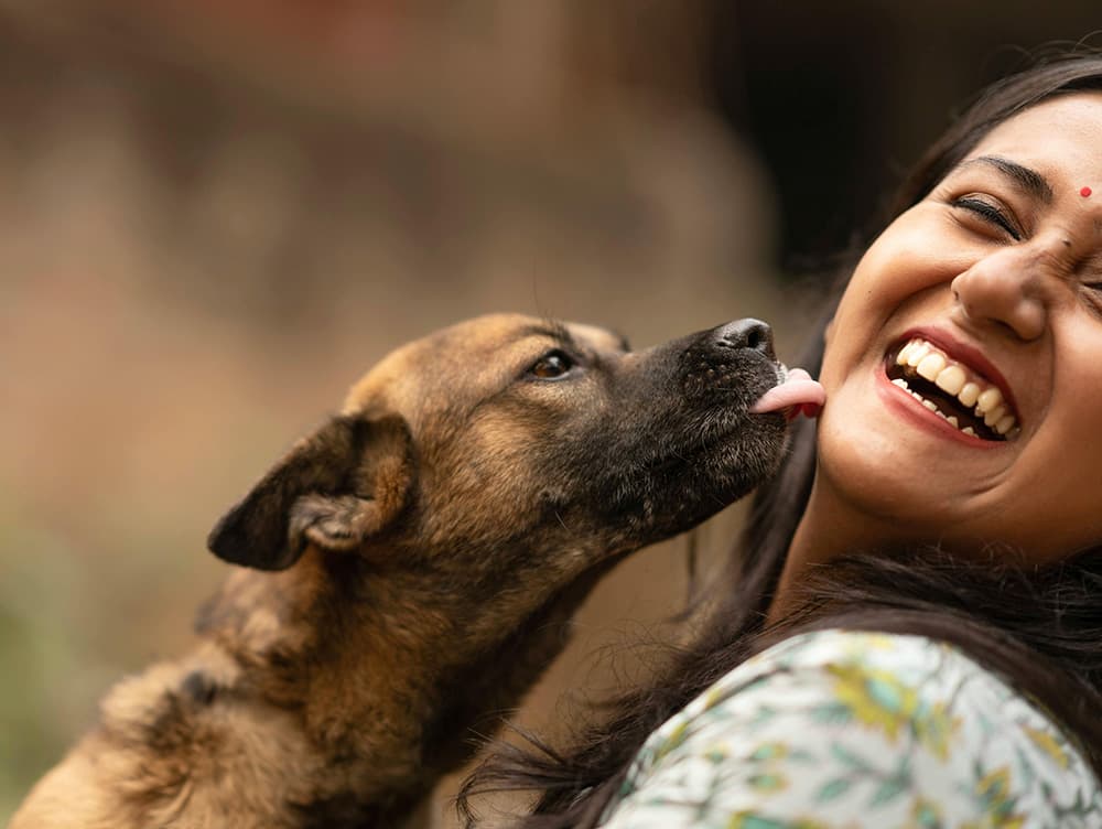 dog licking woman's face